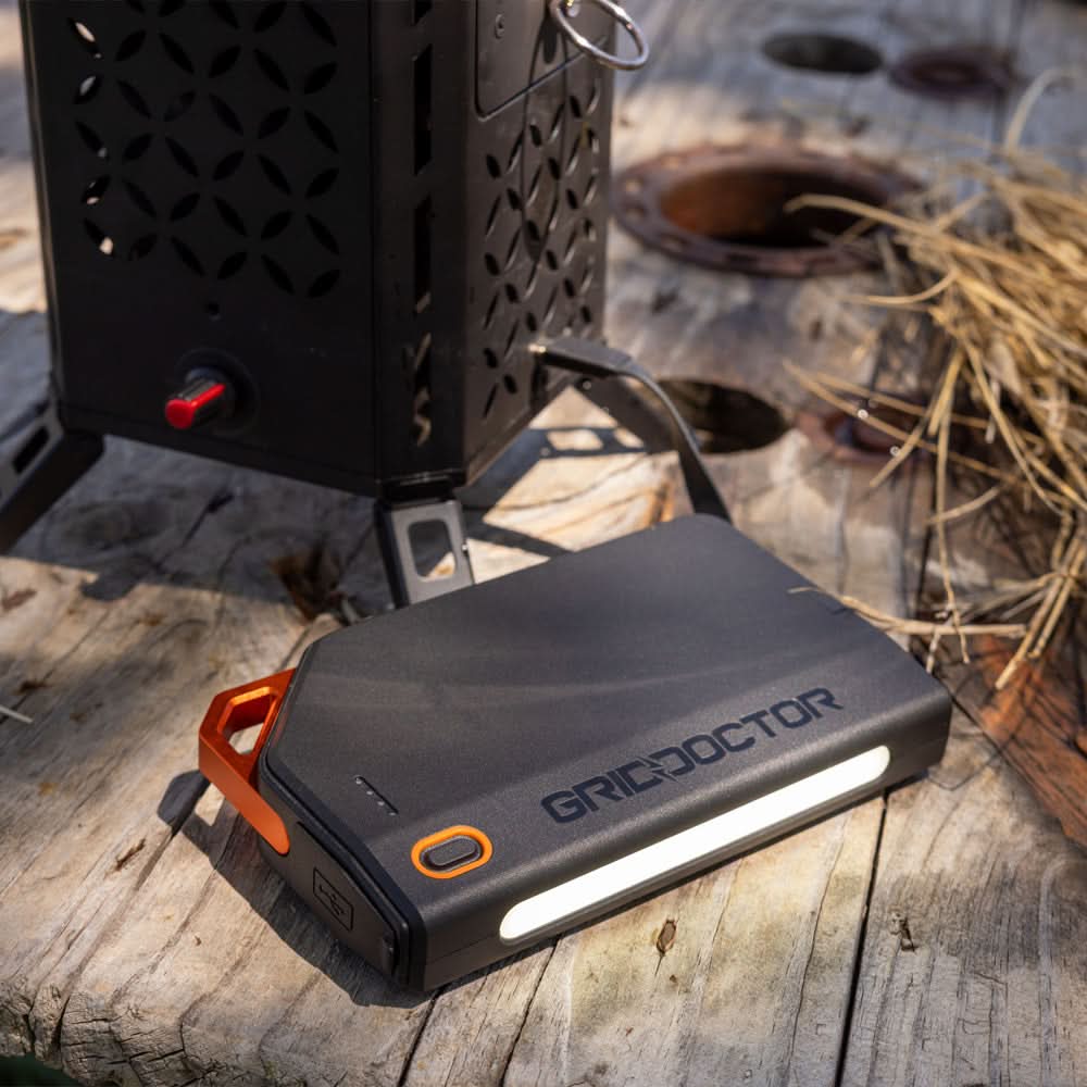 Grid Doctor 65W Power Bank with built-in LED light in an outdoor setting