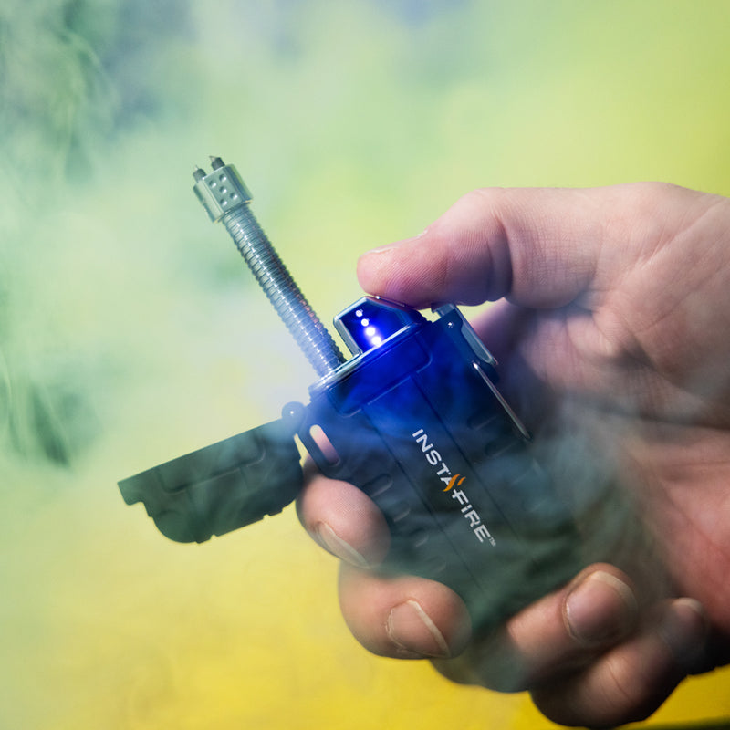 Hand holding ignited Pocket Plasma Lighter by InstaFire with blue plasma.
