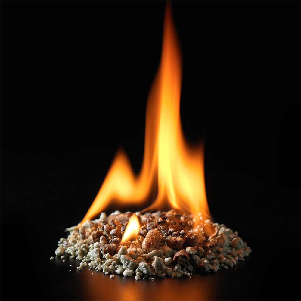 InstaFire Fire Starter & Fuel burning with tall orange flames against a black background to demonstrate ignition.