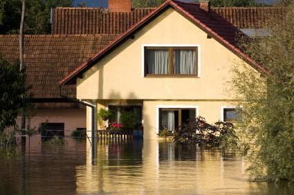 Flooded house after heavy rain in the evening sunlight.