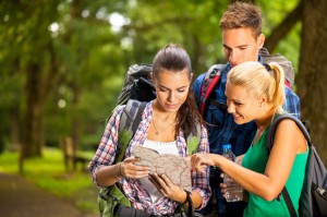 Three hikers watching the map