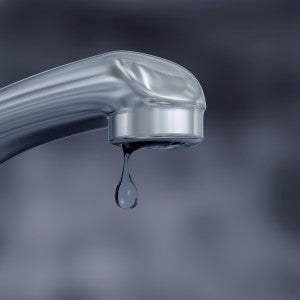 A dripping tap showing water being wasted - conserve water