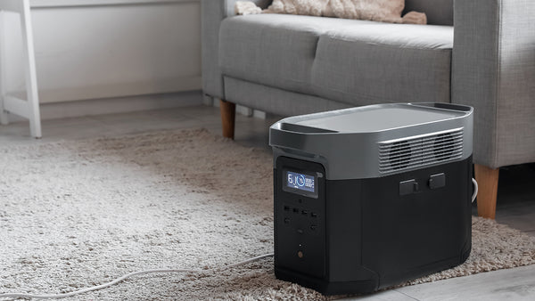 An indoor generator sitting on the floor in a house.