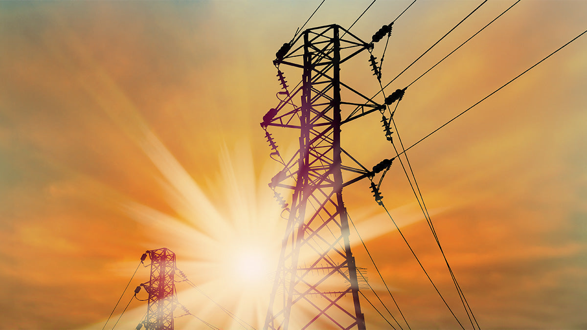 Power lines in front of a sunset
