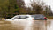 Two cars stuck in a flood. 