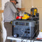 Grid Doctor 2200 solar generator in use, supplying power to various power tools, demonstrating its utility and portability. (7404114083980)