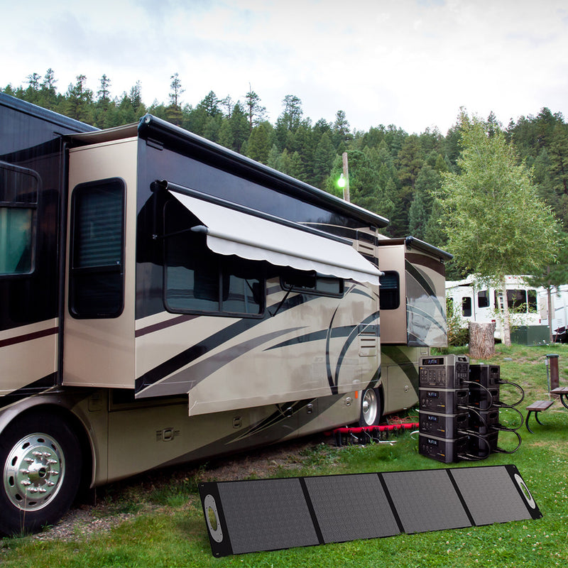 Complete Grid Doctor solar power system with unfolded solar panel, 2200 battery, and 'Power Tower' featuring multiple 2200XP batteries, efficiently powering an RV in a sunny outdoor setting. (7404114083980)