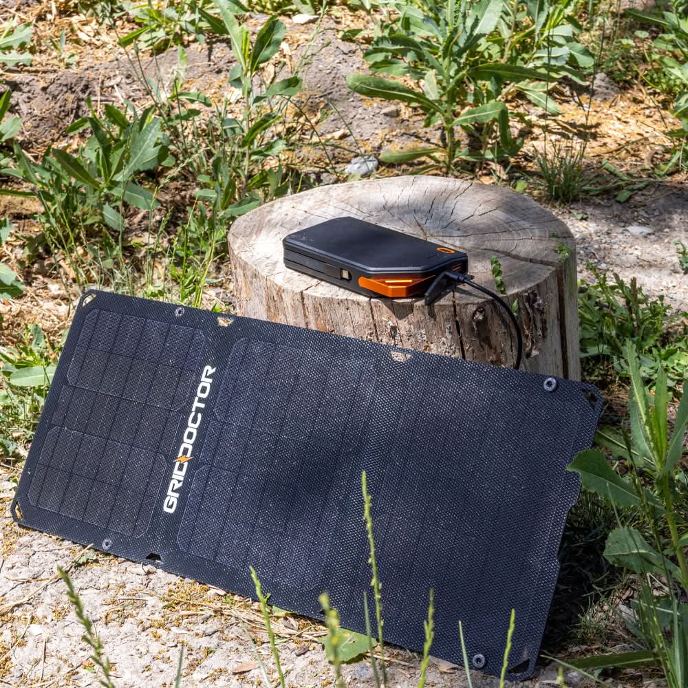 Grid Doctor 15W Solar Panel charging the 65W Power Bank outdoors