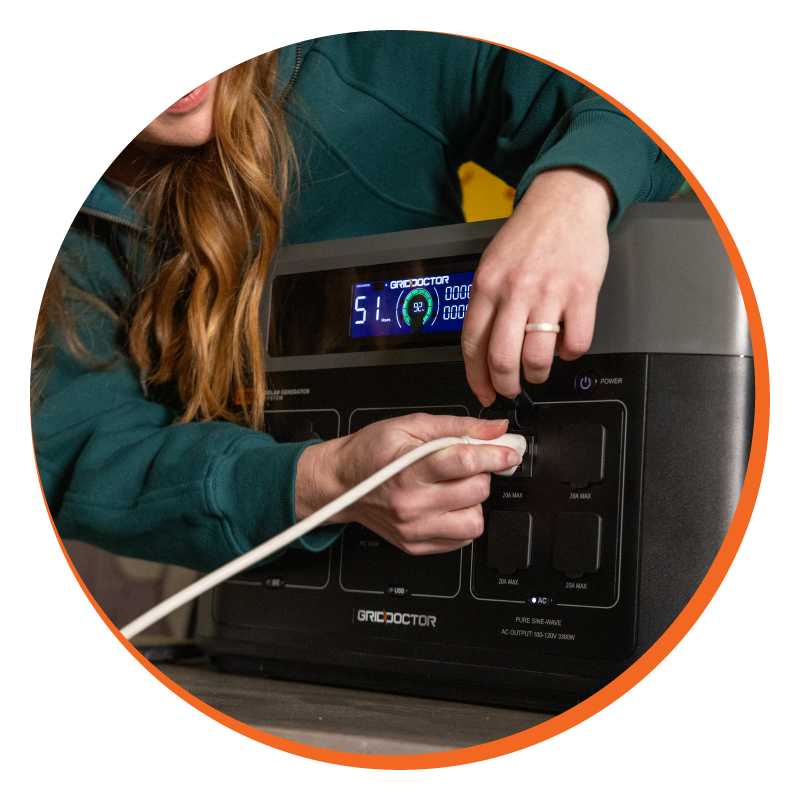 Woman plugging a white cable into the Grid Doctor 3300