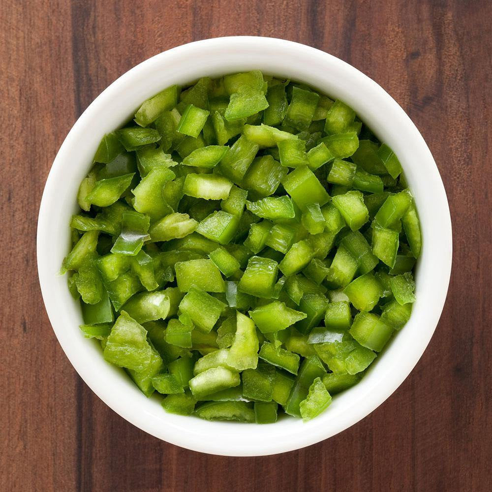Prepared diced green bell peppers served in a bowl