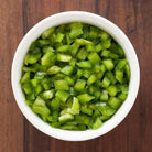 Prepared diced green bell peppers served in a bowl
