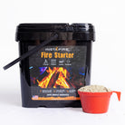 InstaFire Fire Starter & Fuel 2-gallon bucket with orange scoop filled with fire starter granules on a white background.