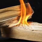 Orange flames burning on stacked firewood ignited with InstaFire Fire Starter & Fuel for outdoor fire starting.