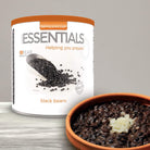Emergency Essentials Black Beans #10 can with scoop of dried black beans, up to 30-year shelf life.